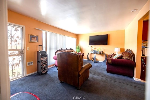 2224 Mortimer St, Huntington Park, CA 90255 - living room featuring dark colored carpet and baseboards