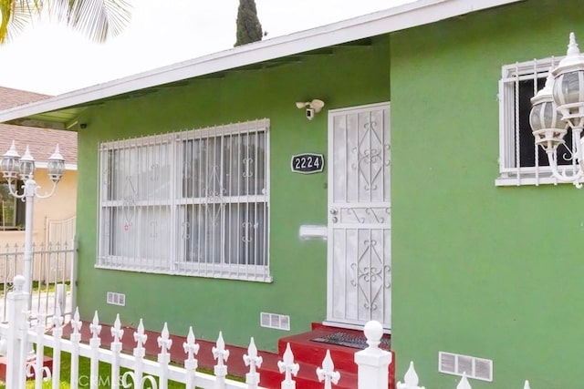 2224 Mortimer St, Huntington Park, CA 90255 - view of exterior entry with stucco siding and fence