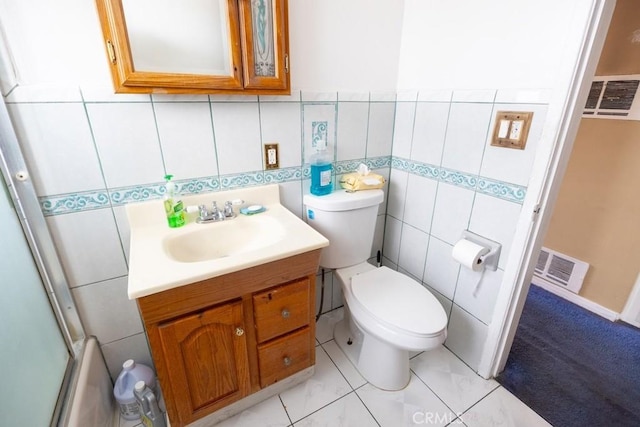 2224 Mortimer St, Huntington Park, CA 90255 - bathroom featuring toilet, vanity, and tile walls