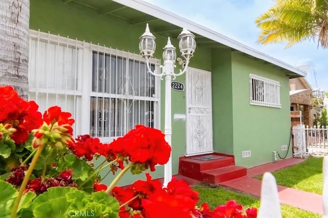 2224 Mortimer St, Huntington Park, CA 90255 - property entrance with fence and stucco siding