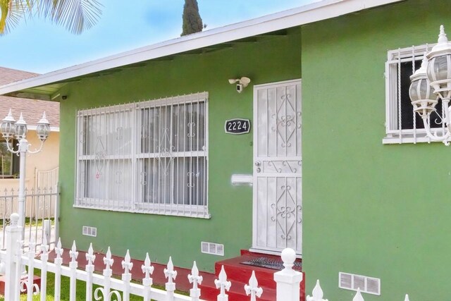 2224 Mortimer St, Huntington Park, CA 90255 - property entrance featuring stucco siding and fence