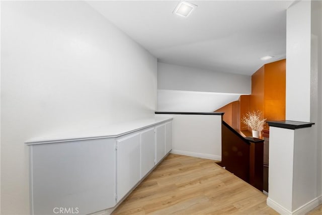 10693 Berrywood Cir, Yucaipa, CA 92399 - hall with an upstairs landing, light wood finished floors, and baseboards