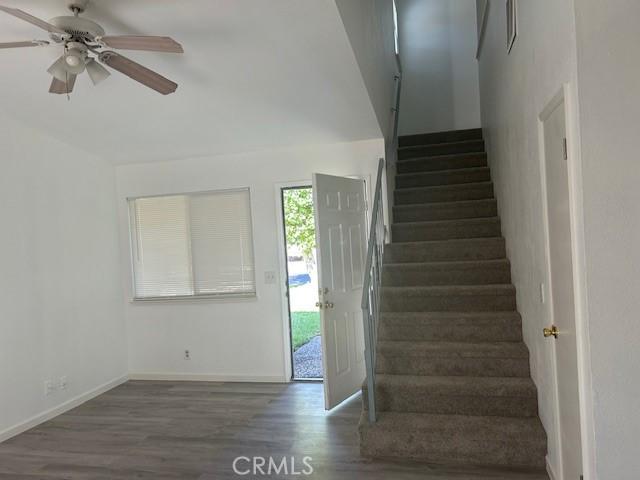 2729 Ceres Ave, Chico, CA 95973 - stairway with ceiling fan, wood finished floors, and baseboards