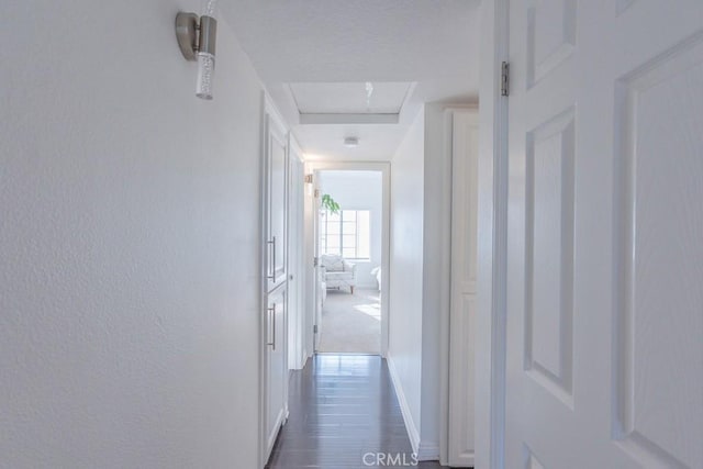 18213 Flynn Dr Unit 132, Canyon Country, CA 91387 - hallway with baseboards and dark wood-style flooring