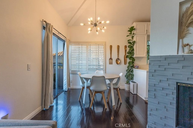 18213 Flynn Dr Unit 132, Canyon Country, CA 91387 - dining space featuring a chandelier, vaulted ceiling, dark wood-type flooring, and baseboards