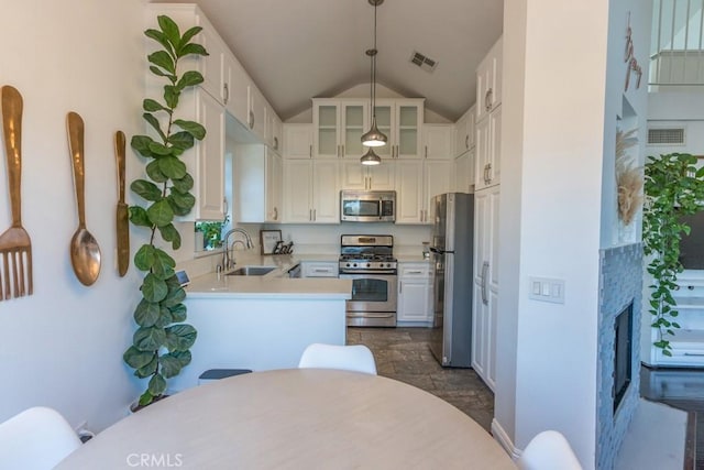 18213 Flynn Dr Unit 132, Canyon Country, CA 91387 - kitchen featuring appliances with stainless steel finishes, a sink, light countertops, glass insert cabinets, and white cabinetry