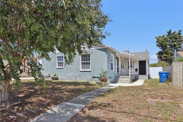 view of front of property with a porch, crawl space, and stucco siding