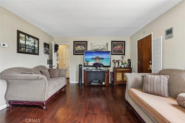 living area featuring dark wood-style flooring and baseboards