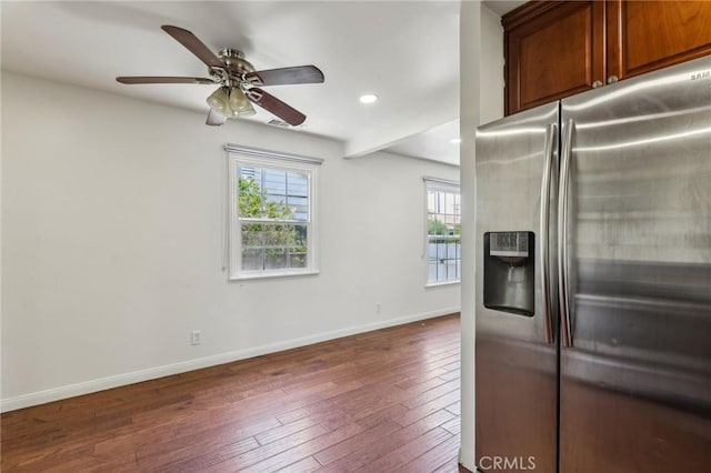 kitchen featuring stainless steel refrigerator with ice dispenser, healthy amount of natural light, baseboards, dark wood-type flooring, and recessed lighting