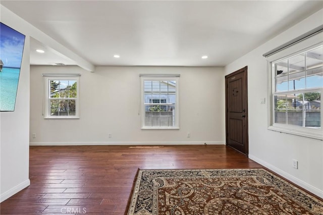 unfurnished room with hardwood / wood-style flooring, recessed lighting, and baseboards