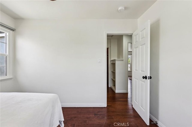 bedroom with wood finished floors and baseboards