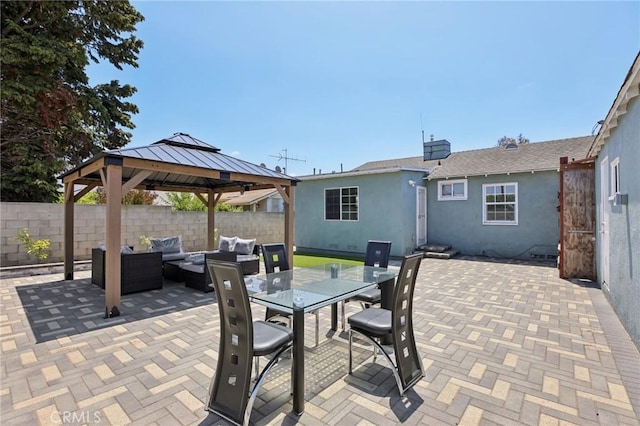 view of patio featuring outdoor lounge area, a fenced backyard, and a gazebo