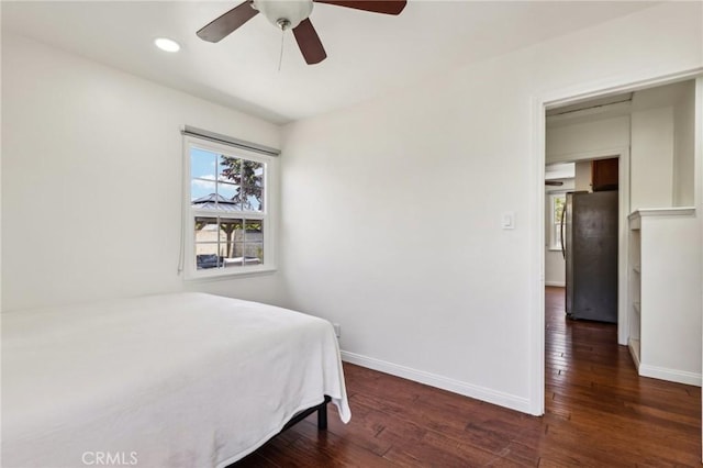 bedroom featuring freestanding refrigerator, wood finished floors, baseboards, recessed lighting, and a ceiling fan