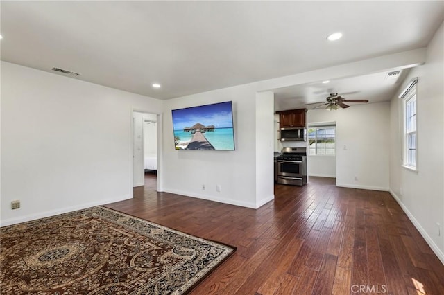 empty room with dark wood-style floors, a ceiling fan, baseboards, and recessed lighting