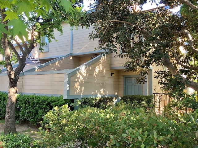 view of side of home featuring fence
