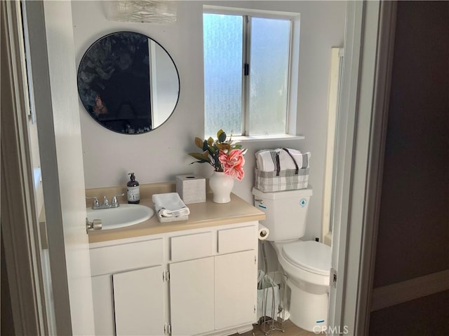 bathroom featuring vanity and toilet