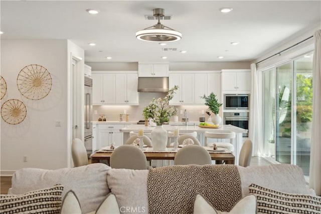 26288 Meadow Dr, San Juan Capistrano, CA 92675 - kitchen with stainless steel appliances, open floor plan, white cabinets, an island with sink, and light countertops