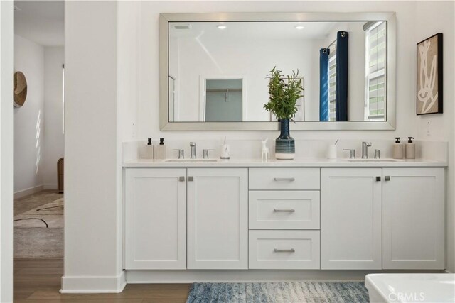 26288 Meadow Dr, San Juan Capistrano, CA 92675 - bathroom featuring baseboards, double vanity, and wood finished floors