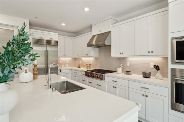 26288 Meadow Dr, San Juan Capistrano, CA 92675 - kitchen with under cabinet range hood, built in appliances, a sink, white cabinetry, and recessed lighting