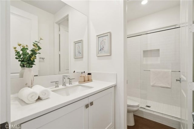 26288 Meadow Dr, San Juan Capistrano, CA 92675 - bathroom with toilet, a stall shower, vanity, wood finished floors, and recessed lighting