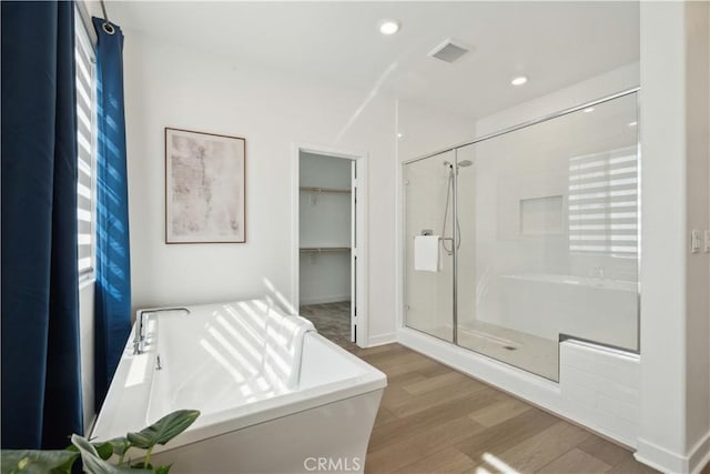 26288 Meadow Dr, San Juan Capistrano, CA 92675 - full bathroom featuring a stall shower, a freestanding tub, wood finished floors, and a spacious closet