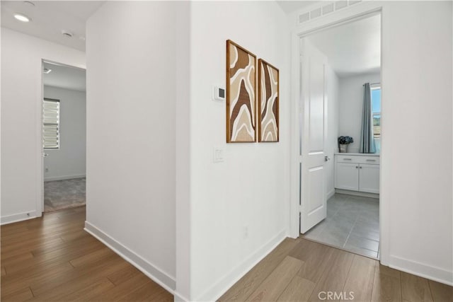 26288 Meadow Dr, San Juan Capistrano, CA 92675 - corridor featuring wood finished floors, healthy amount of natural light, and baseboards