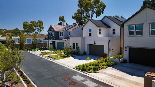 26288 Meadow Dr, San Juan Capistrano, CA 92675 - view of front of property featuring stucco siding, an attached garage, concrete driveway, roof mounted solar panels, and a residential view