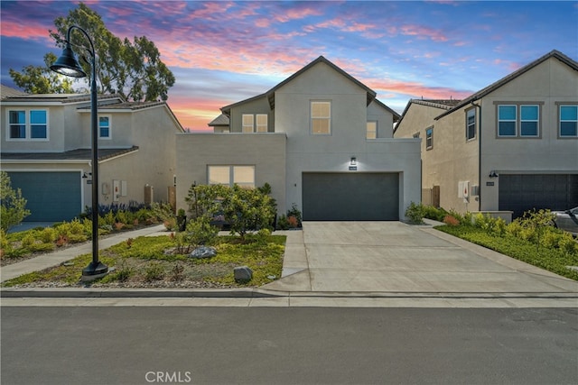 26288 Meadow Dr, San Juan Capistrano, CA 92675 - view of front facade featuring an attached garage, stucco siding, and driveway