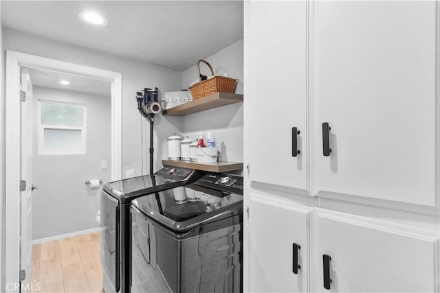 laundry room with washing machine and clothes dryer, light wood finished floors, baseboards, and recessed lighting