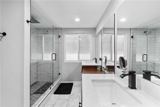 full bathroom with a shower stall, baseboards, double vanity, and recessed lighting