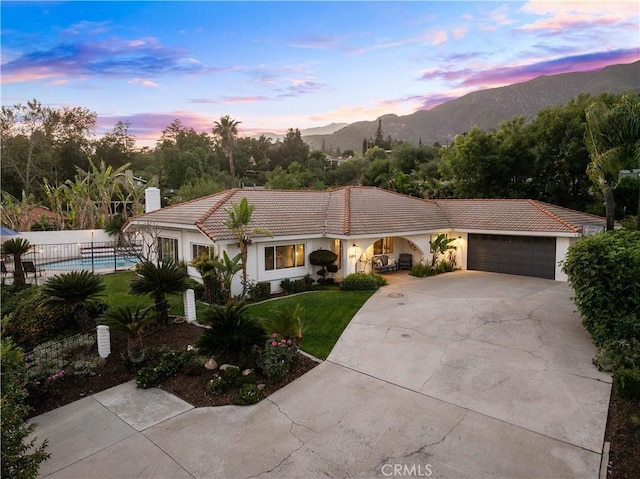 2485 San Mateo Dr, Upland, CA 91784 - view of front of property featuring concrete driveway, a tile roof, an attached garage, a mountain view, and stucco siding