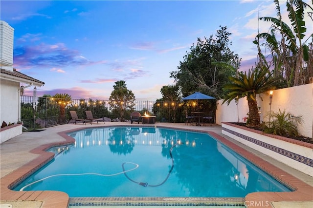 view of pool with a fenced backyard and a patio