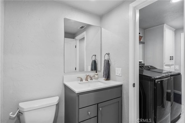 2485 San Mateo Dr, Upland, CA 91784 - bathroom with washing machine and dryer, a textured wall, and vanity