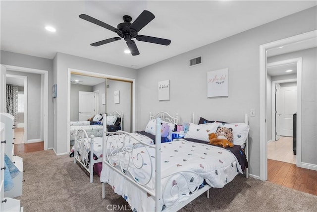carpeted bedroom featuring a closet, recessed lighting, baseboards, and ceiling fan