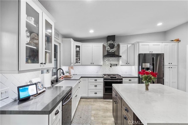 2485 San Mateo Dr, Upland, CA 91784 - kitchen featuring appliances with stainless steel finishes, wall chimney range hood, tasteful backsplash, white cabinets, and recessed lighting