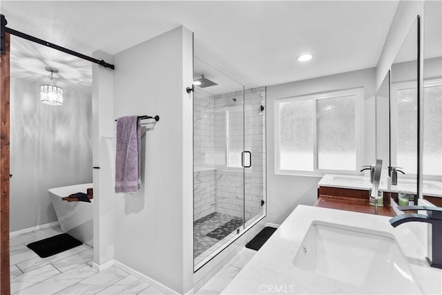 full bath featuring a shower stall, double vanity, baseboards, a freestanding tub, and marble finish flooring