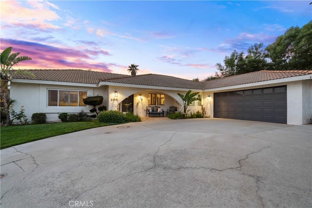 2485 San Mateo Dr, Upland, CA 91784 - ranch-style home featuring driveway, stucco siding, an attached garage, a tiled roof, and a front yard