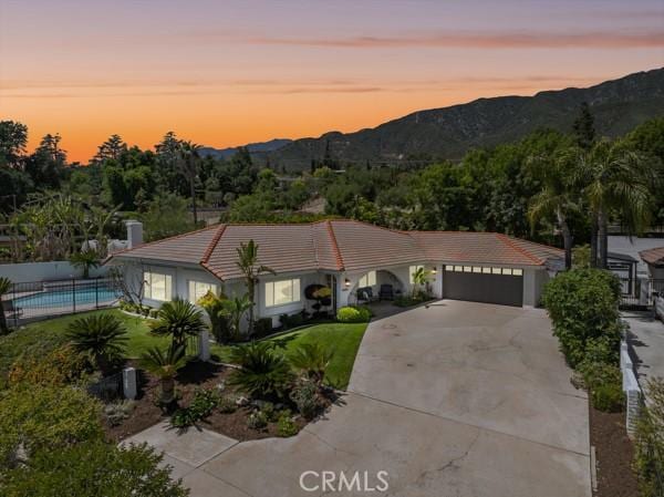 2485 San Mateo Dr, Upland, CA 91784 - mediterranean / spanish house with a tiled roof, driveway, an attached garage, and a mountain view
