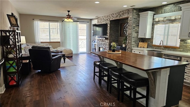 13817 Grant Way, Oak Hills, CA 92344 - kitchen featuring a sink, ceiling fan, dark wood-type flooring, wood counters, and a kitchen breakfast bar