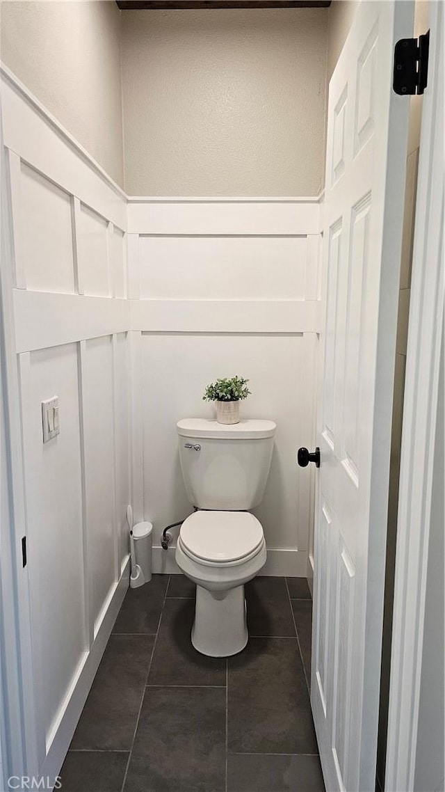 13817 Grant Way, Oak Hills, CA 92344 - bathroom featuring toilet, tile patterned floors, and a decorative wall