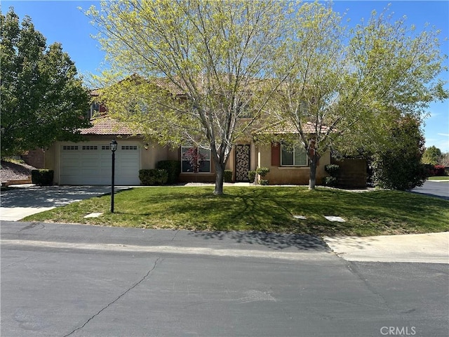 41053 Knoll Dr, Palmdale, CA 93551 - view of property hidden behind natural elements with concrete driveway, a front lawn, and stucco siding