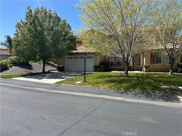 41053 Knoll Dr, Palmdale, CA 93551 - view of property hidden behind natural elements featuring stucco siding, driveway, a front yard, and an attached garage