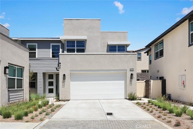 15842 Caterpillar Dr, Fontana, CA 92336 - contemporary home featuring concrete driveway, stucco siding, and an attached garage