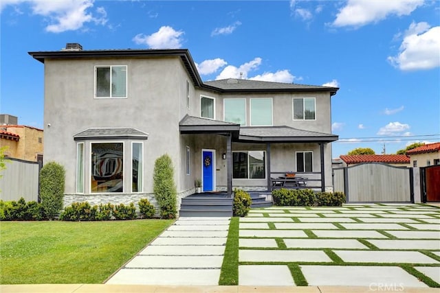 8910 S 3rd Ave, Inglewood, CA 90305 - view of front facade featuring a gate, stucco siding, and covered porch