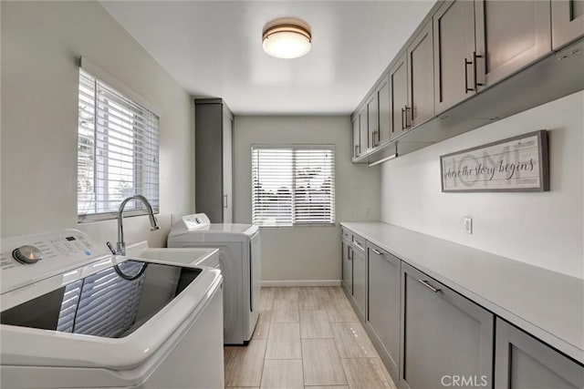 8910 S 3rd Ave, Inglewood, CA 90305 - clothes washing area featuring washer and dryer, cabinet space, and baseboards