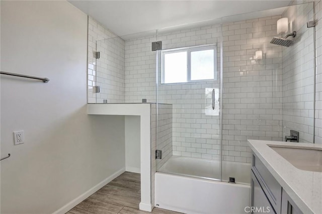 8910 S 3rd Ave, Inglewood, CA 90305 - bathroom featuring baseboards, combined bath / shower with glass door, wood finished floors, and vanity