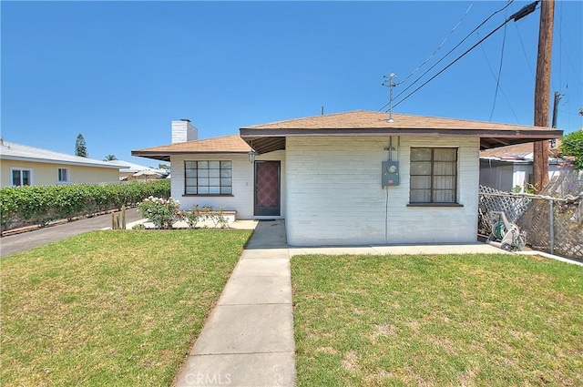 321 Aguirre Ln, Placentia, CA 92870 - view of front facade featuring a chimney, brick siding, and roof with shingles