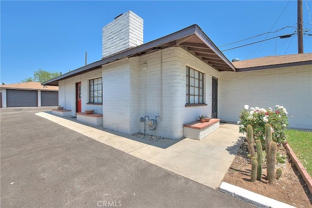 321 Aguirre Ln, Placentia, CA 92870 - view of side of property featuring a chimney and an outdoor structure