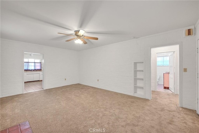 321 Aguirre Ln, Placentia, CA 92870 - spare room featuring carpet floors, ceiling fan, crown molding, and brick wall