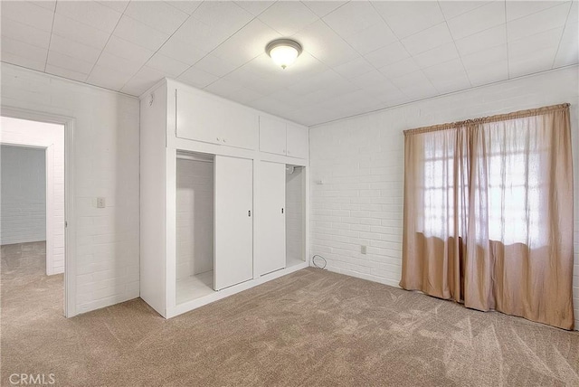 321 Aguirre Ln, Placentia, CA 92870 - unfurnished bedroom with carpet, a closet, and brick wall